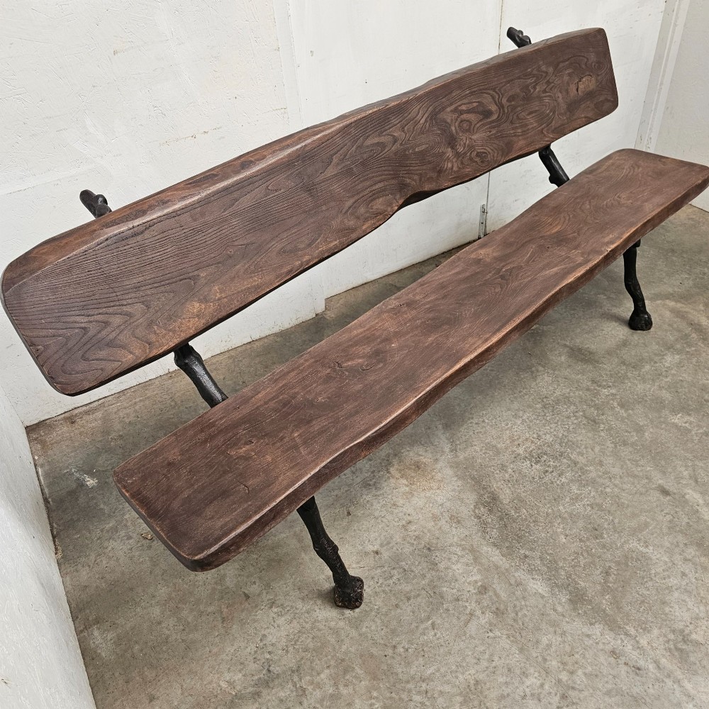 A rustic French garden bench featuring a dark elm slab seat and backrest supported by black cast iron legs designed to resemble natural tree branches. View III