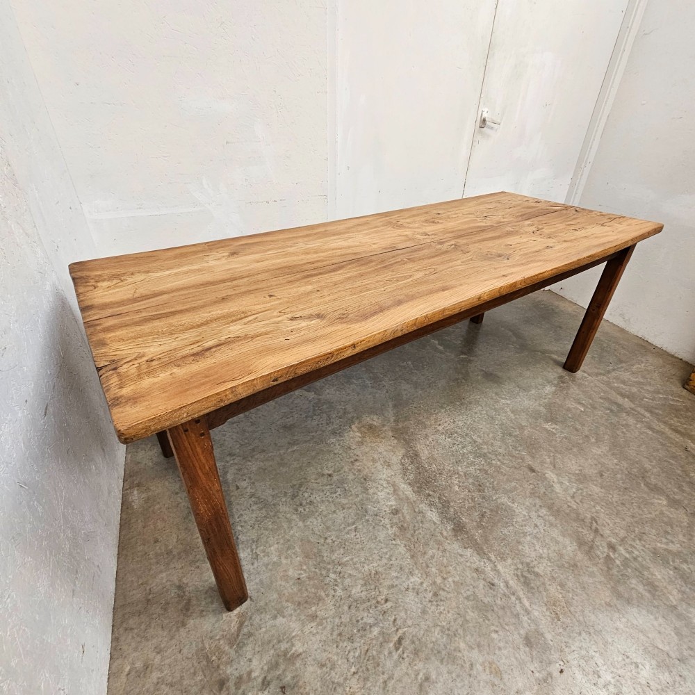 A French rustic elm farmhouse dining table featuring a two-plank top, a pull-out side slide, and square tapered legs. View II