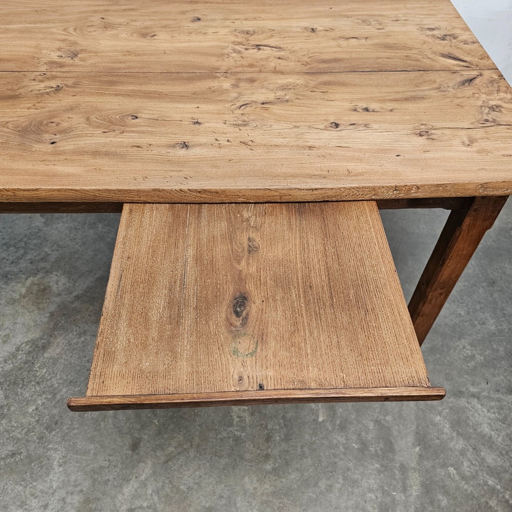 A French rustic elm farmhouse dining table featuring a two-plank top, a pull-out side slide, and square tapered legs. View IV