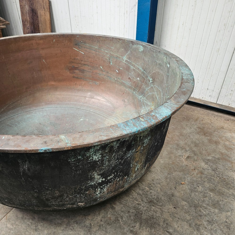 A massive antique French copper cheese vat with a reinforced rim, showing an oxidised exterior with verdigris green highlights. View III