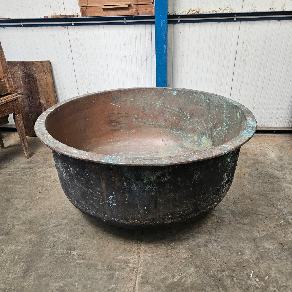 A massive antique French copper cheese vat with a reinforced rim, showing an oxidised exterior with verdigris green highlights. View V