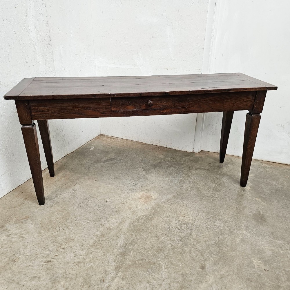 A rectangular dark oak console table featuring four square tapered legs, a single central drawer with a wooden knob, and a flat timber top.