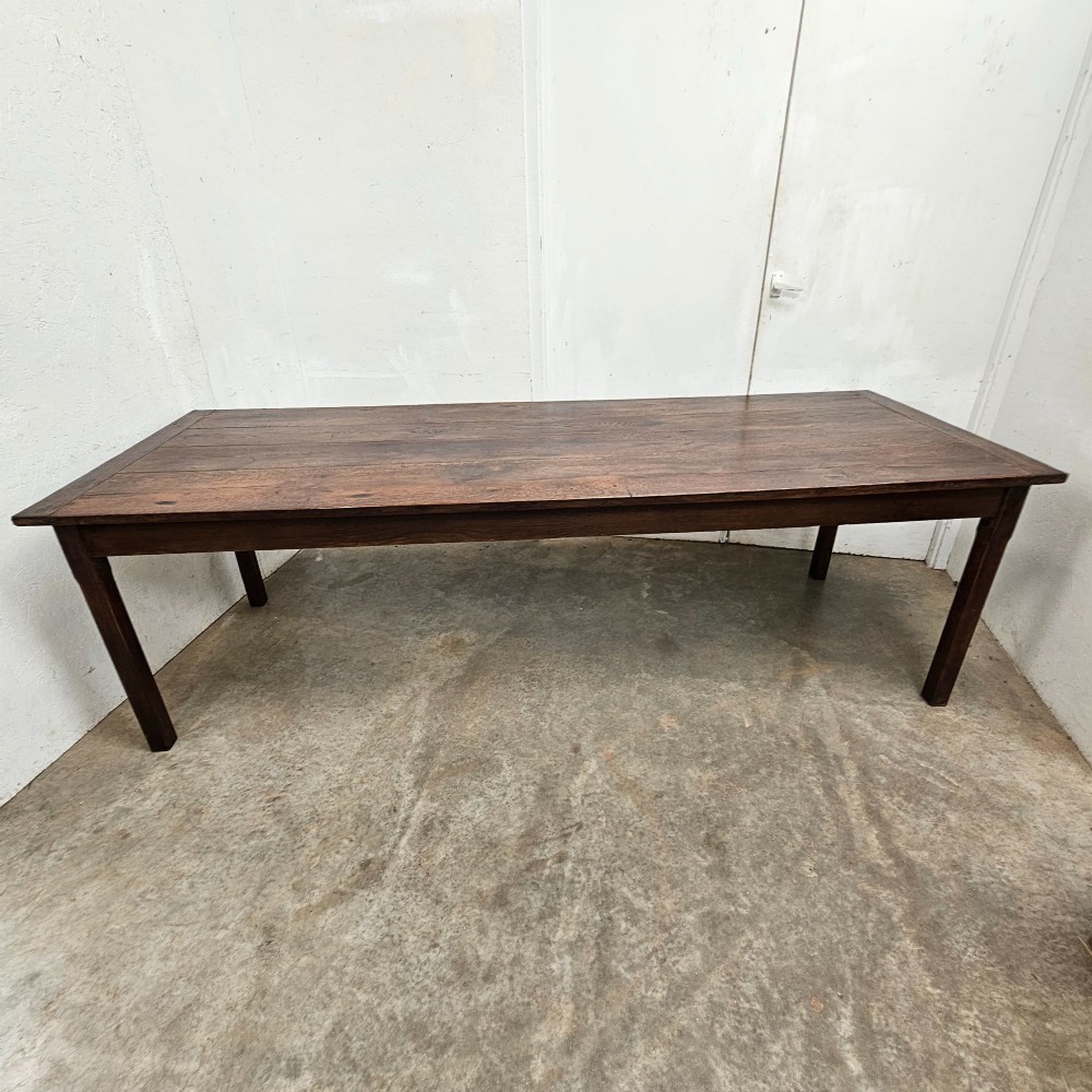An eight-foot French oak farmhouse dining table with a dark patinated plank top, breadboard ends, and sturdy legs. View II