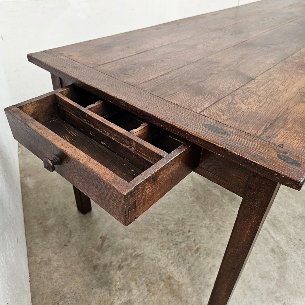 An eight-foot French oak farmhouse dining table with a dark patinated plank top, breadboard ends, and sturdy legs. View III