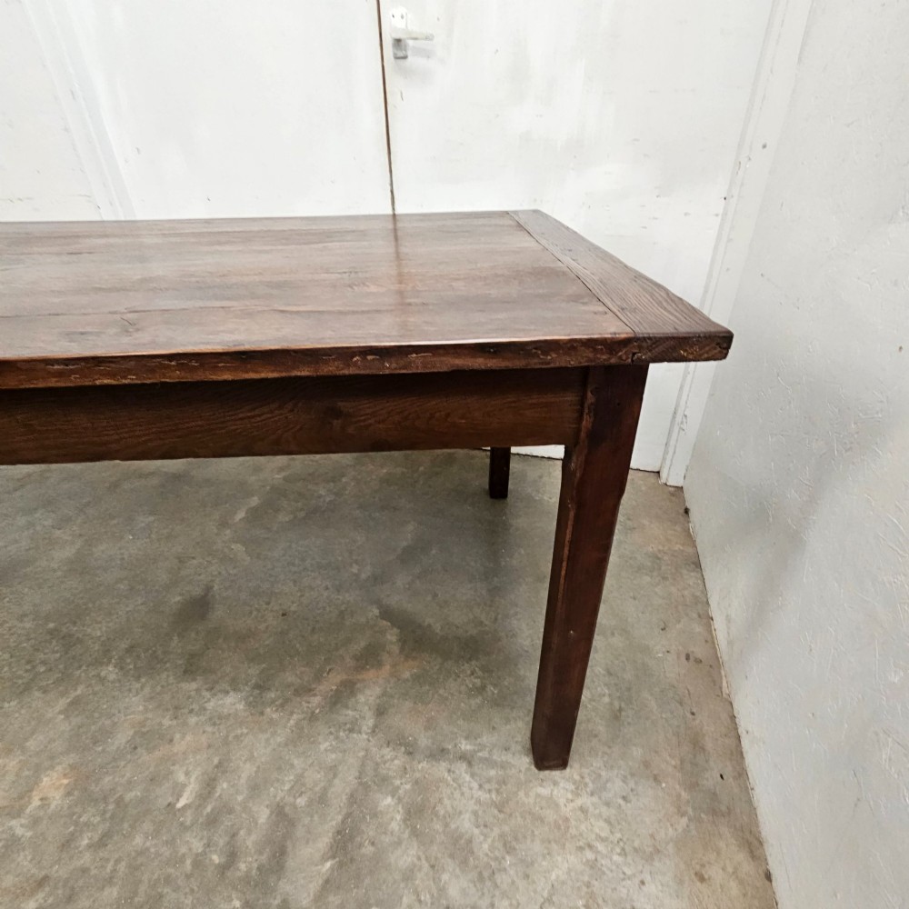 An eight-foot French oak farmhouse dining table with a dark patinated plank top, breadboard ends, and sturdy legs. View VI