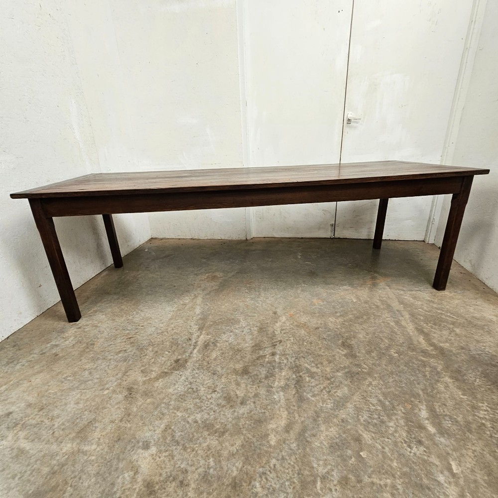 An eight-foot French oak farmhouse dining table with a dark patinated plank top, breadboard ends, and sturdy legs. View VII