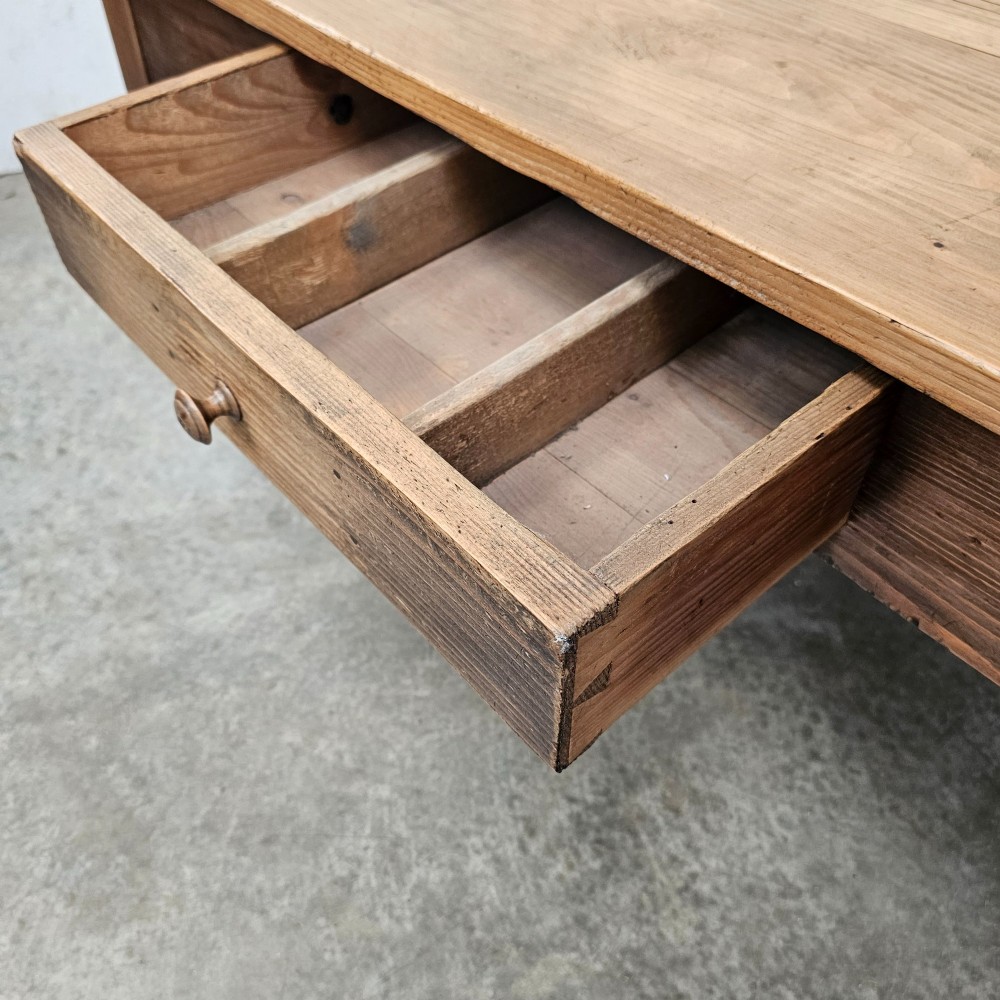 A rectangular rustic pine coffee table featuring four turned legs and a single central frieze drawer with a round wooden knob. View IV