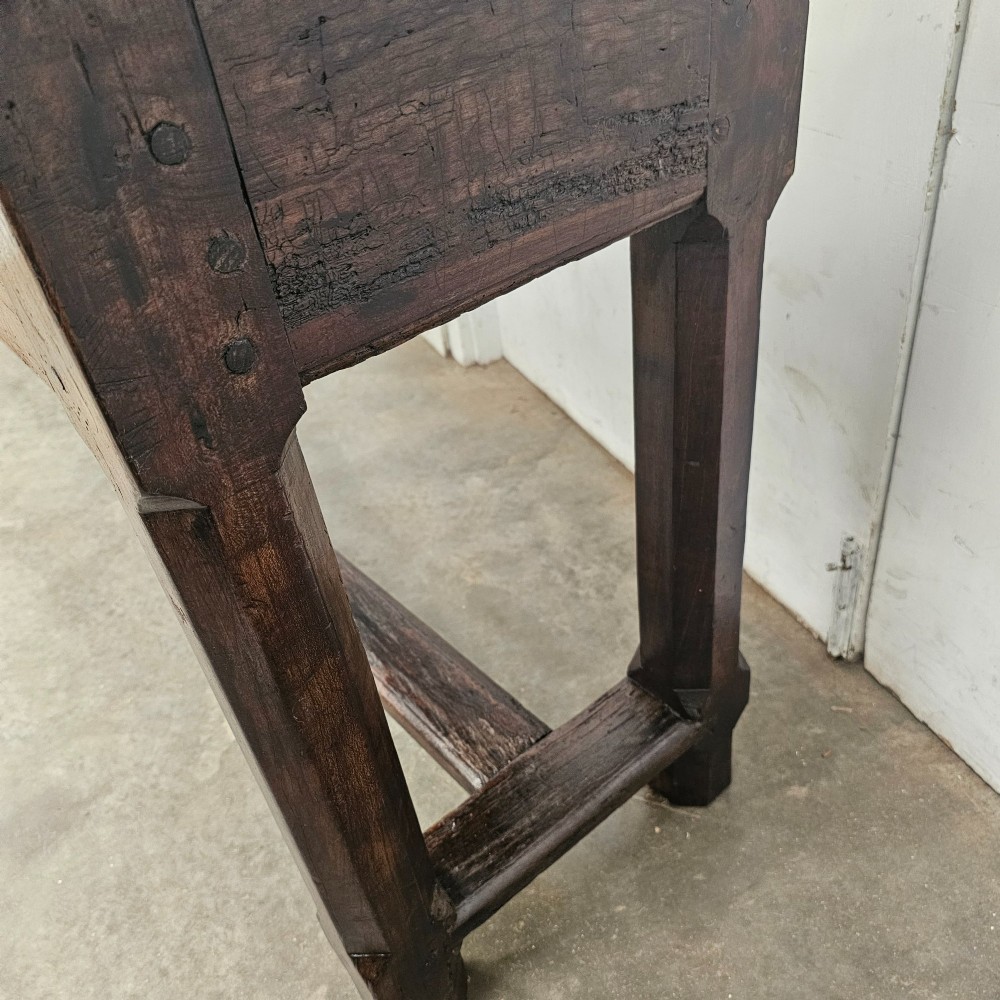 An antique dark fruitwood console table featuring a single central drawer, straight legs, and an H-stretcher base. View III