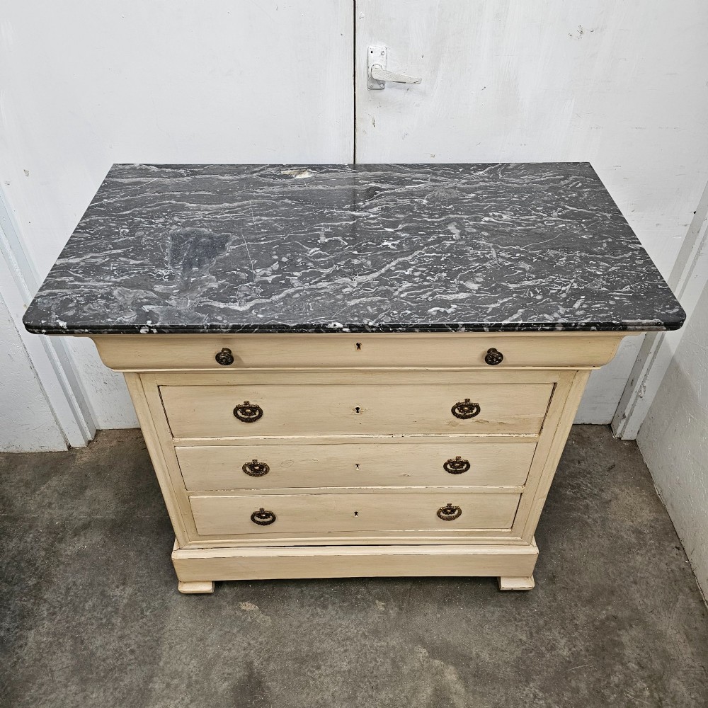 An off-white painted Louis Philippe chest of drawers with a dark marble top and brass ring handles. View II