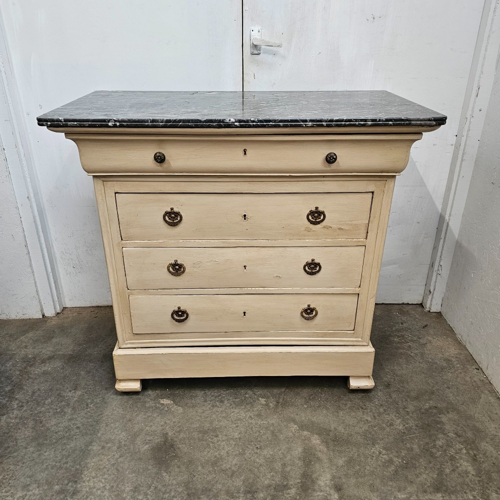 An off-white painted Louis Philippe chest of drawers with a dark marble top and brass ring handles. View III