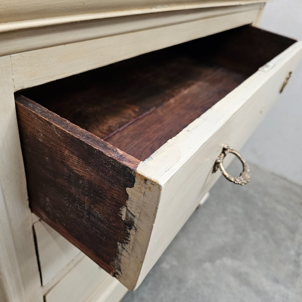 An off-white painted Louis Philippe chest of drawers with a dark marble top and brass ring handles. View VII