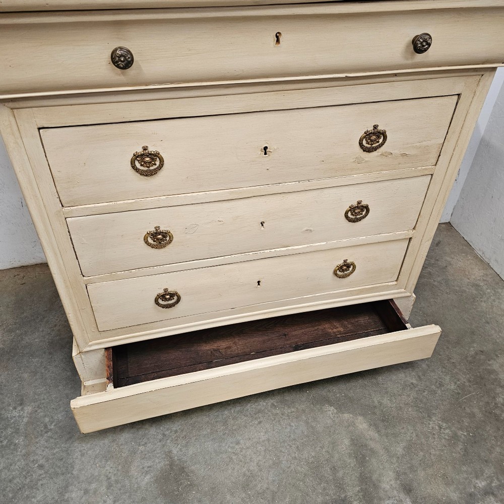 An off-white painted Louis Philippe chest of drawers with a dark marble top and brass ring handles. View VIII