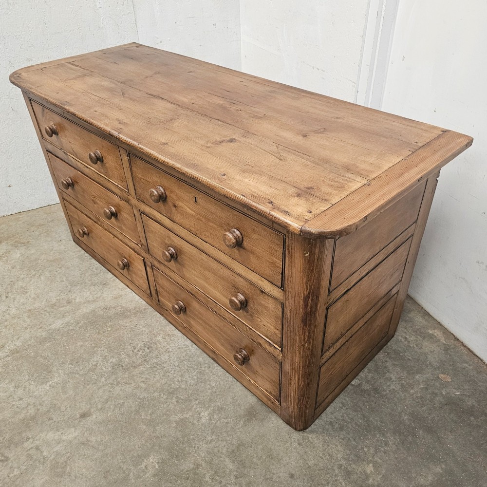 A Victorian waxed pine bank of six drawers arranged in two columns with round turned wooden knobs and a plain plinth base. View IV