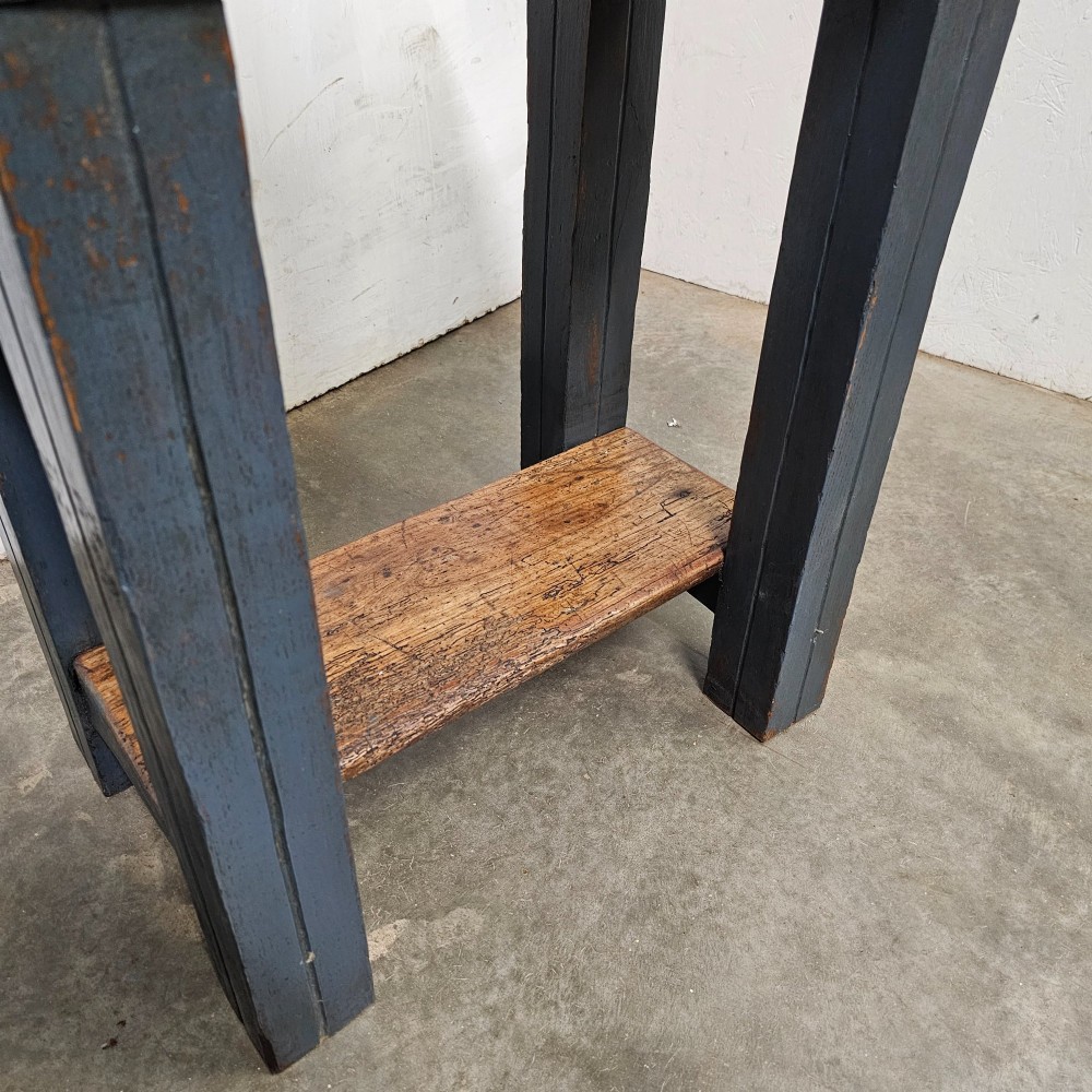 A small antique French butchers block featuring an end-grain beech top with a brass makers plate set on a dark painted wooden stand with a lower shelf. View V
