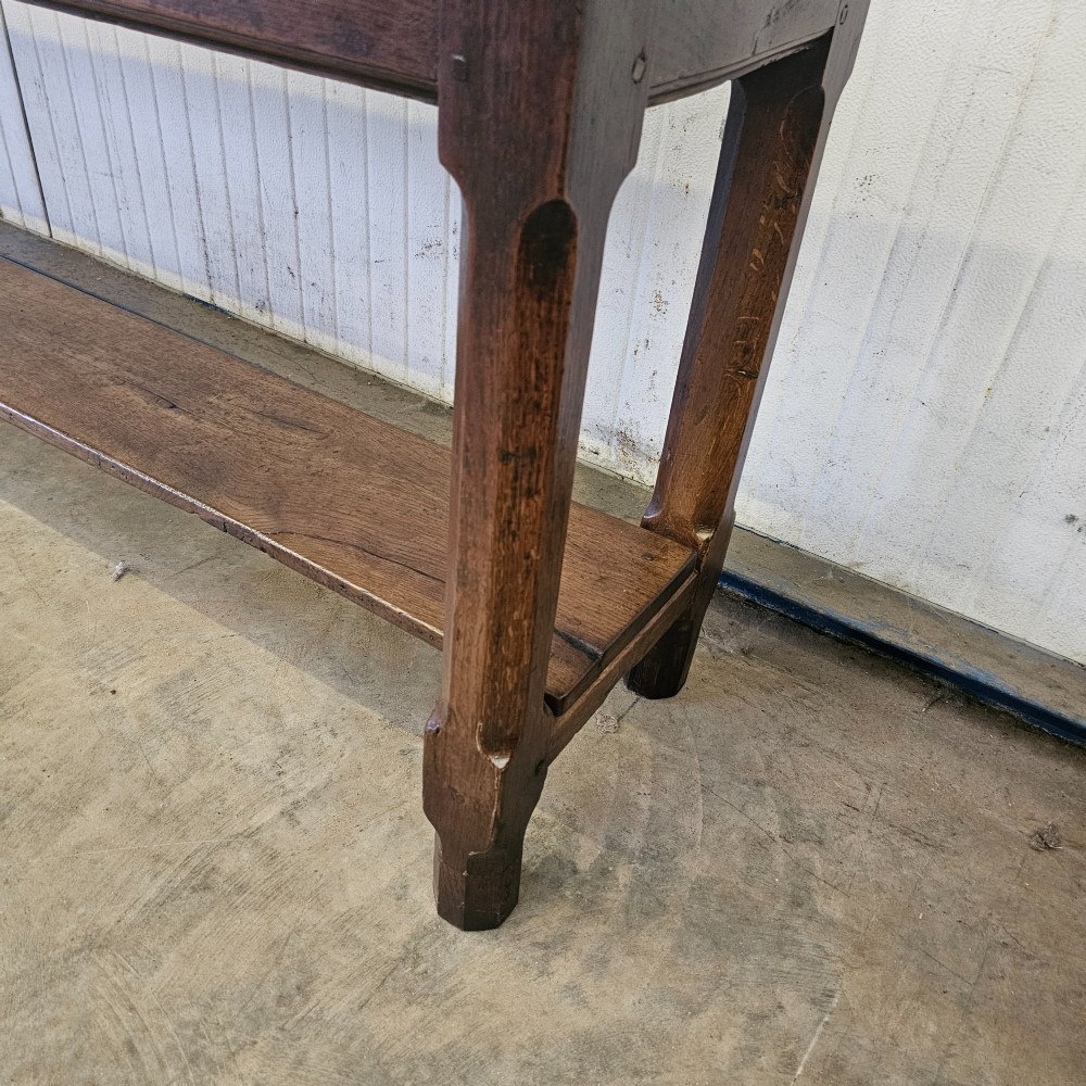 A long, narrow dark oak French serving table featuring a plank top, square legs, and a full-length lower pot shelf. View III