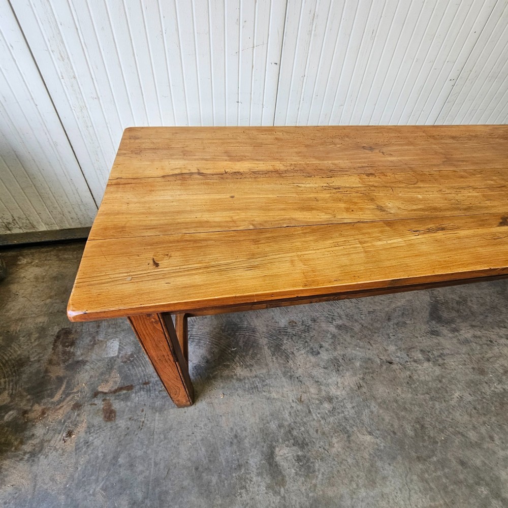 A long French country dining table crafted from beech and elm timber with a plank top and an H-stretcher base. View III