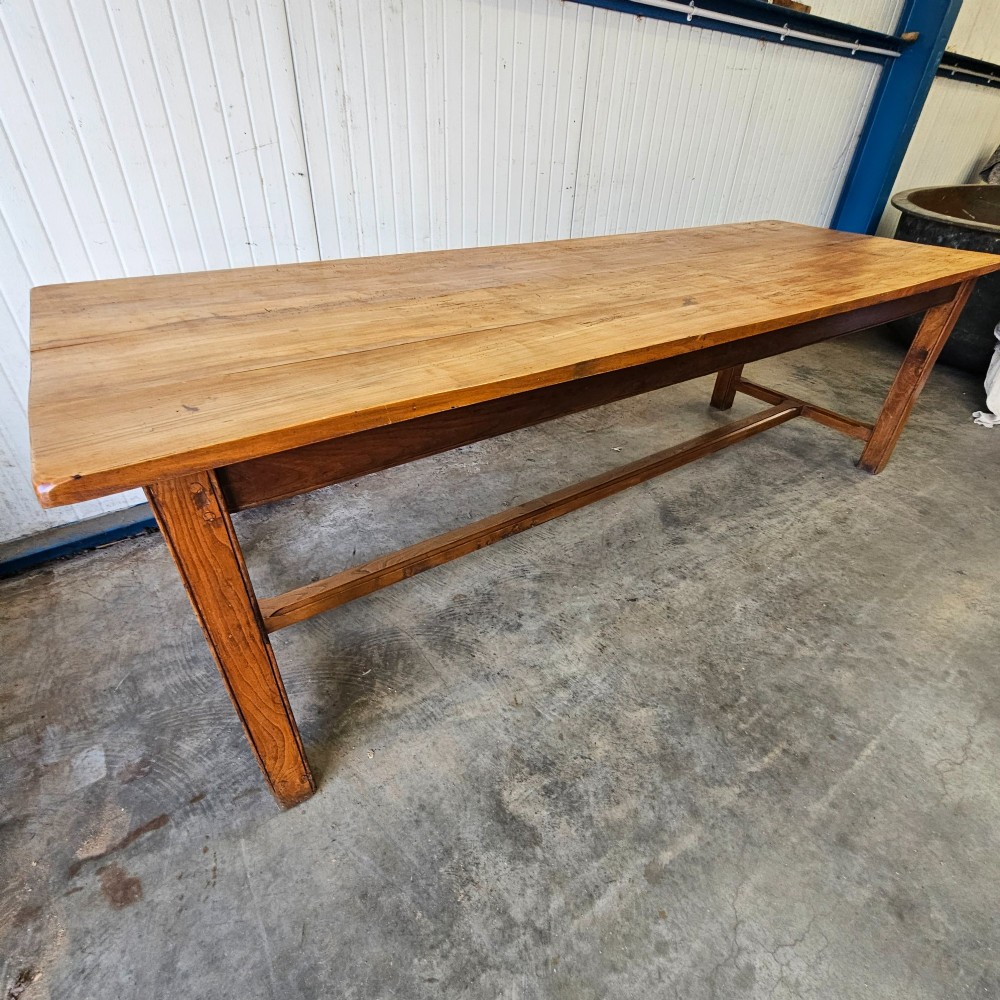 A long French country dining table crafted from beech and elm timber with a plank top and an H-stretcher base. View VI
