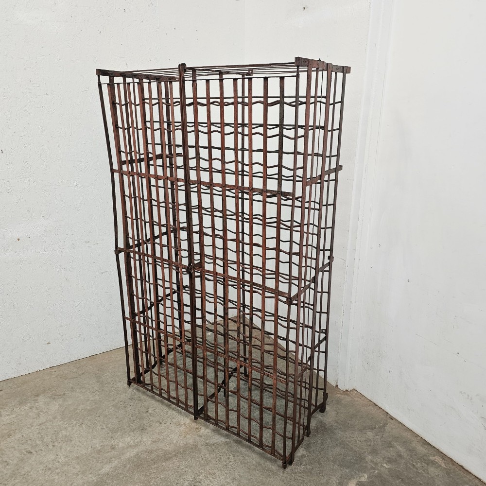 A large freestanding French steel wine rack featuring a open lattice riveted frame with multiple horizontal bottle tiers. View II