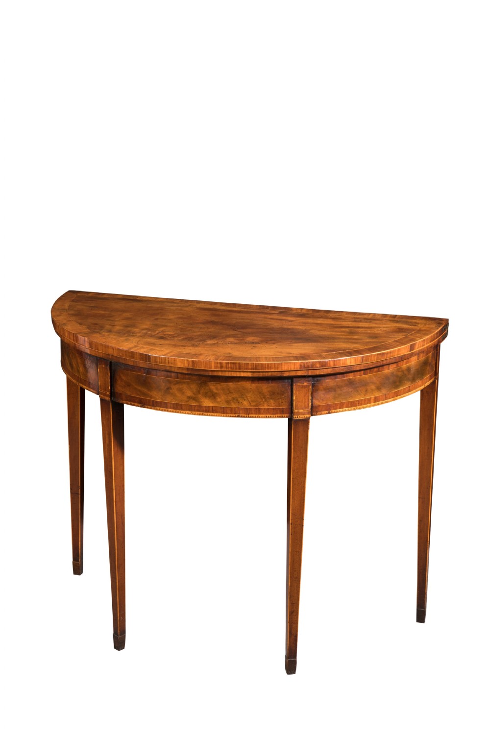 George III mahogany crossbanded demi-lune card table. Circa 1790