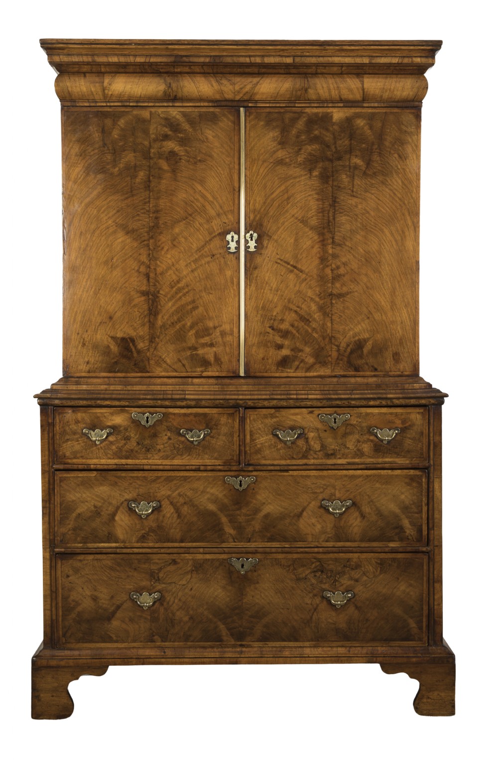 An antique George I walnut cabinet on chest featuring two upper veneered cupboard doors above multiple drawers with brass handles and bracket feet.