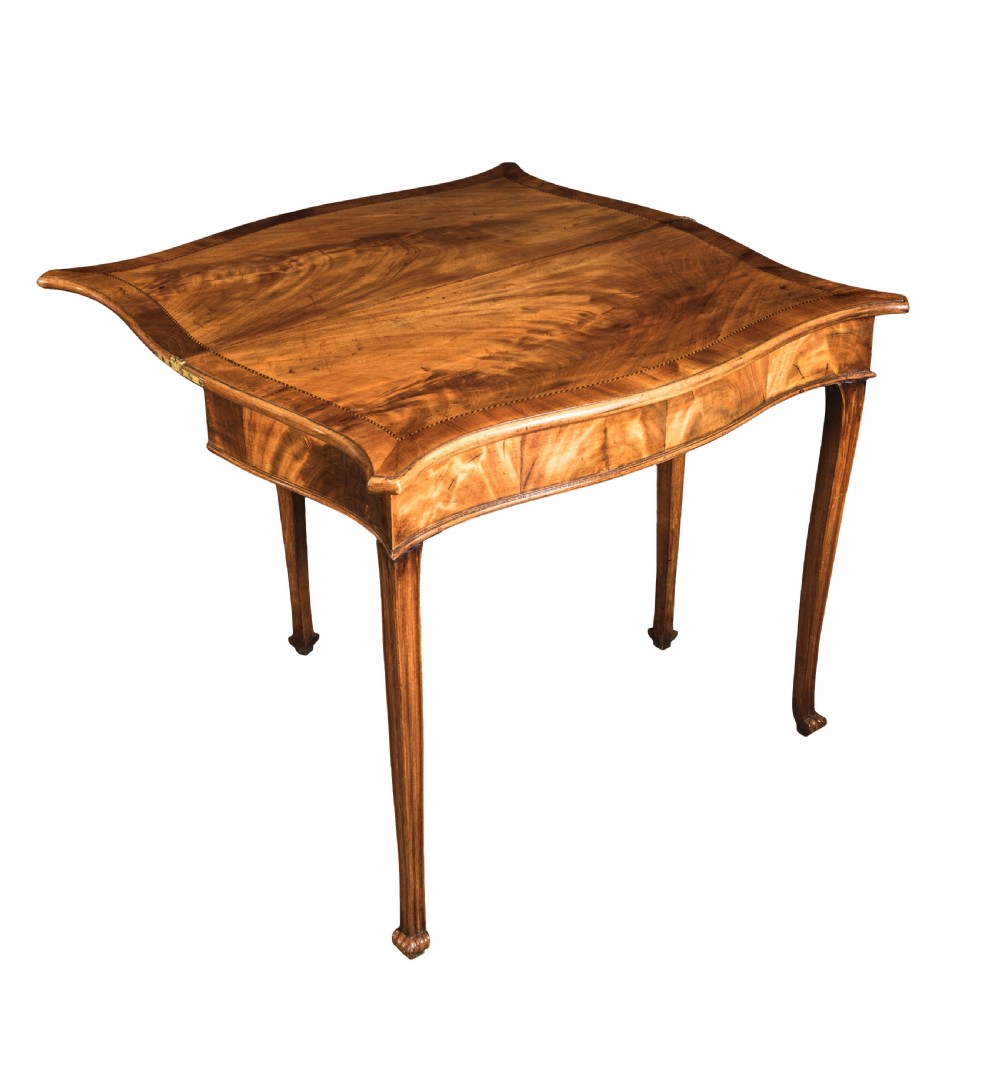 A well-figured George III mahogany Serpentine tea table Circa 1770 View II