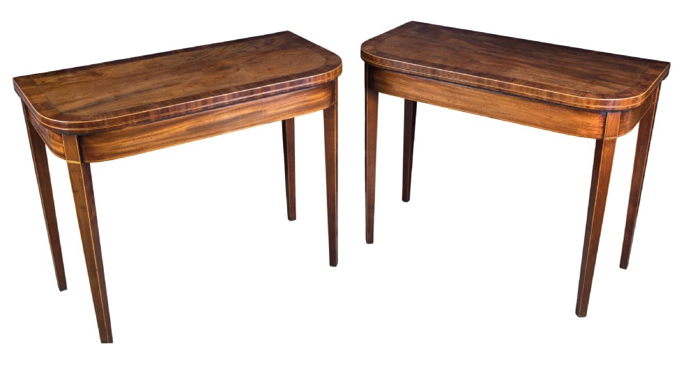 A good pair of George III mahogany D-shaped card tables