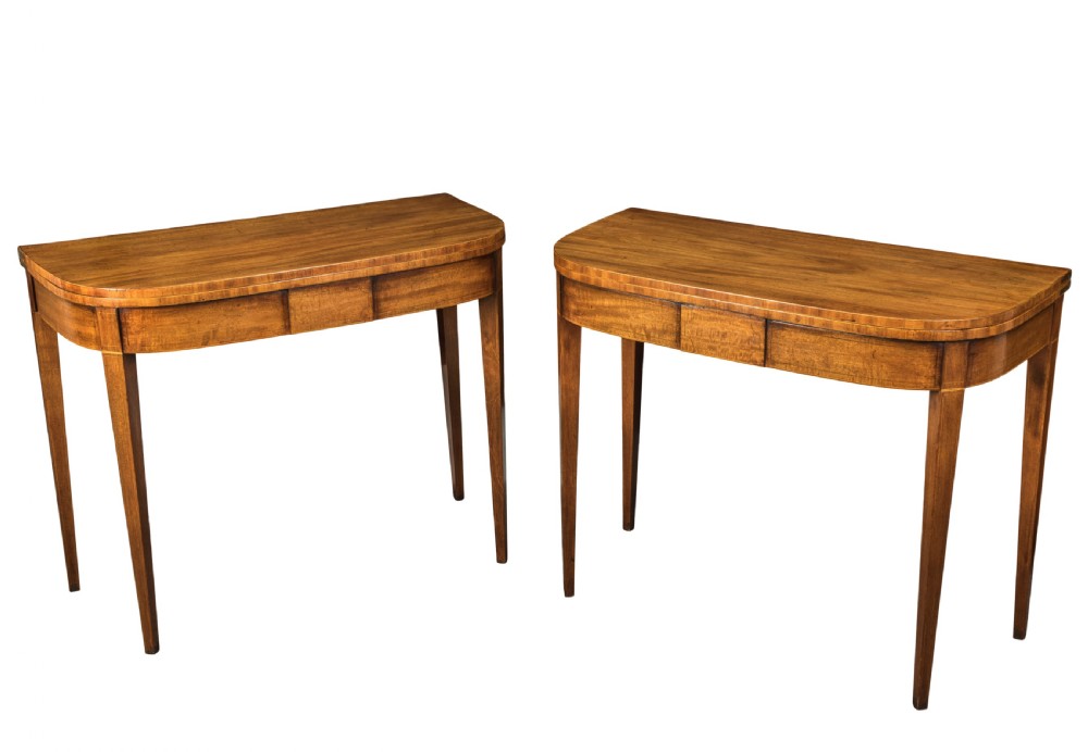 Pair of George III mahogany D-shaped tea tables. Circa 1800