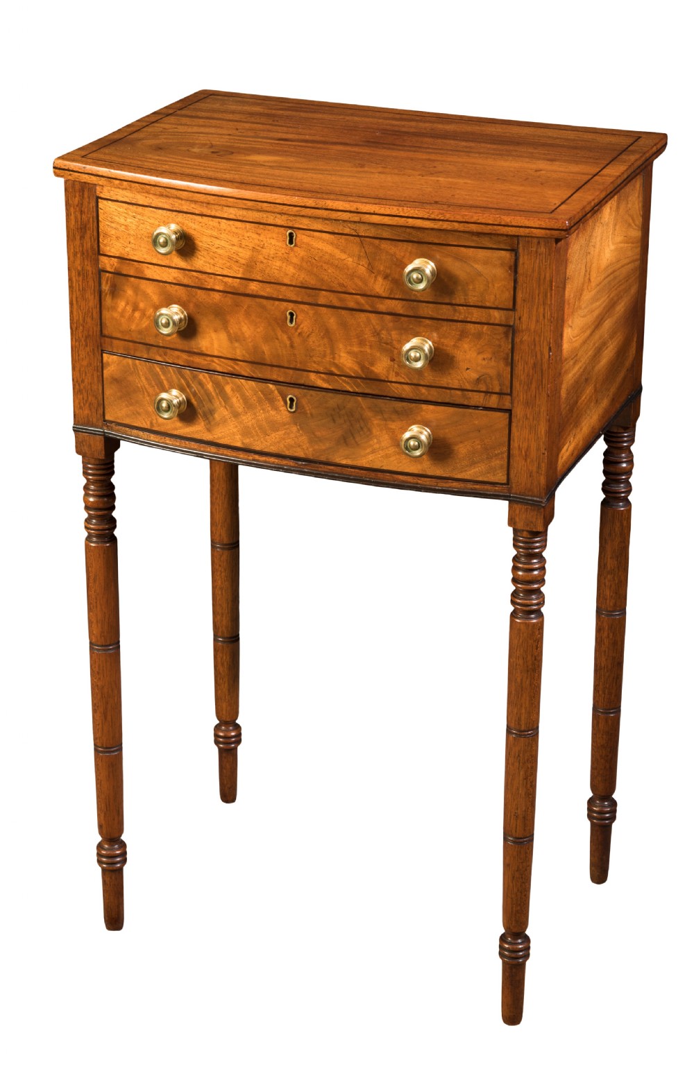 A George III mahogany bowfront work table featuring three drawers with brass turned knobs and ring-turned legs.