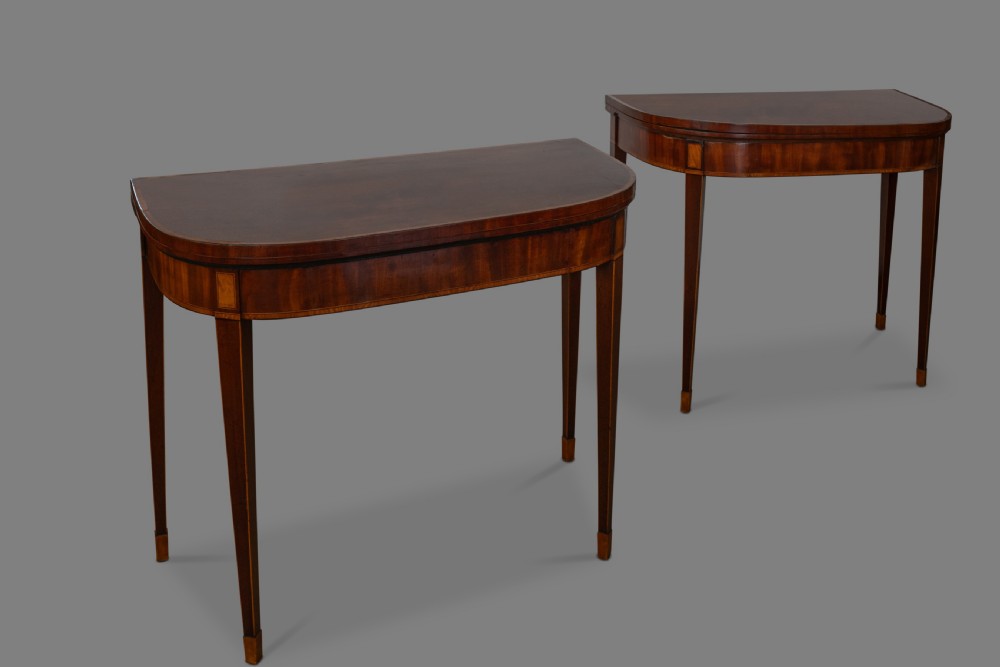 A good pair of George III mahogany D-shaped card tables