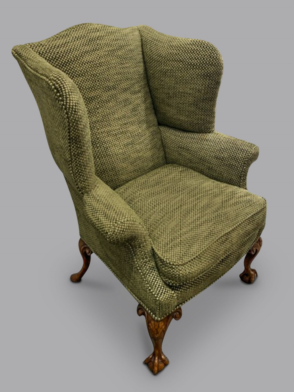 A mid-19th-century Victorian wingback armchair upholstered in textured green fabric with hand-carved walnut cabriole legs. View II