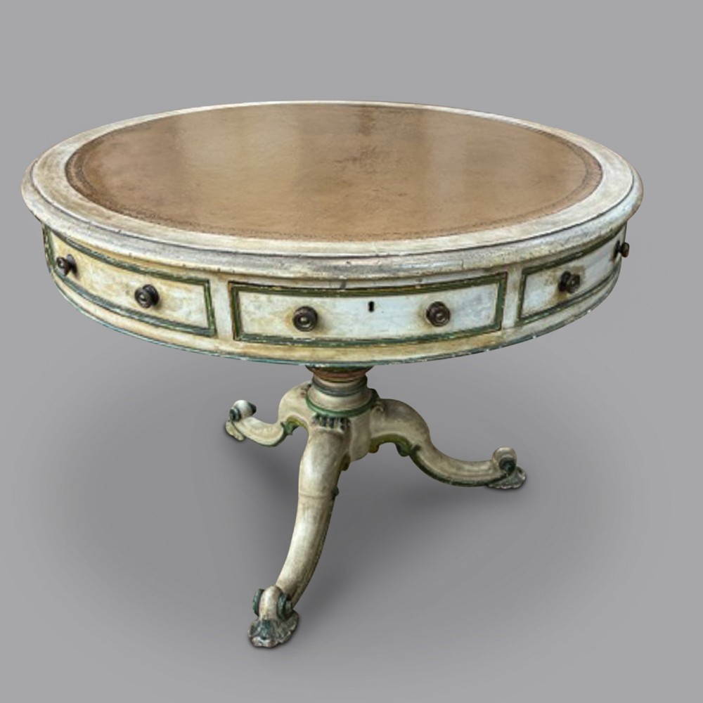 An early 19th-century circular painted drum table featuring a leather-inset surface, frieze drawers, and a central pedestal tripod base.