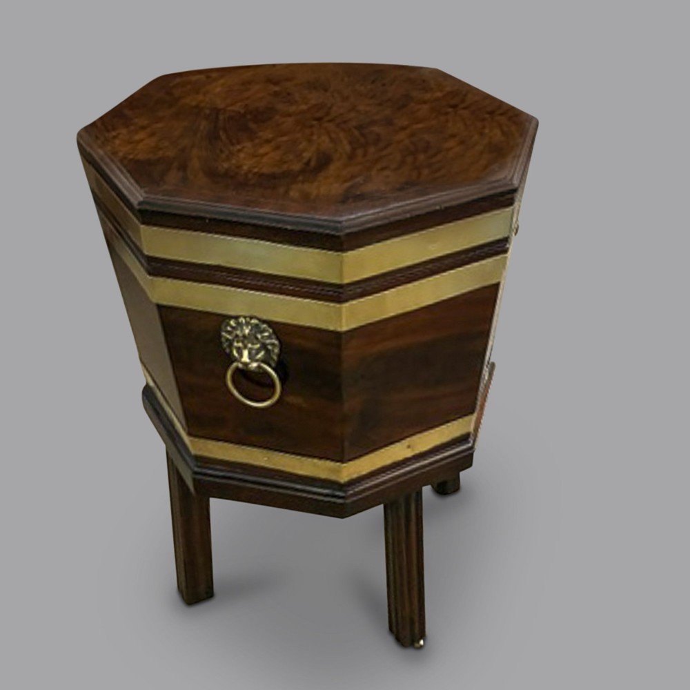 An 18th-century octagonal mahogany wine cooler featuring polished brass binding, a hinged lid with keyhole, and square moulded legs. View II