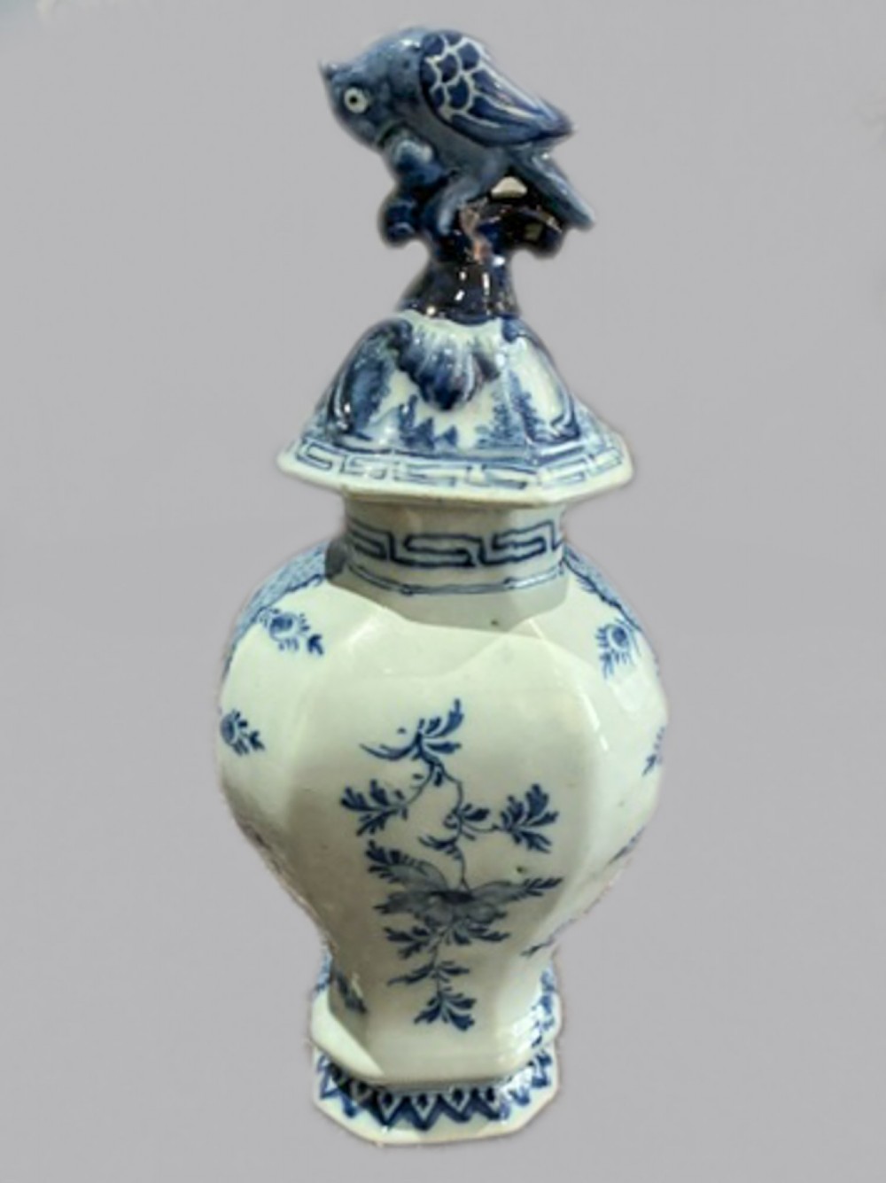 An 18th-century Dutch Delftware lidded vase decorated with blue and white hand-painted chinoiserie landscapes and topped with a sculpted bird finial. View III