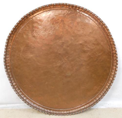 An Oversized Beaten Copper Circular Charger
