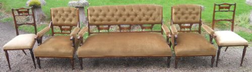 fig 1. A five-piece Edwardian rosewood salon suite featuring a central button-back settee, two matching armchairs, and two side chairs with warm brown velvet upholstery.