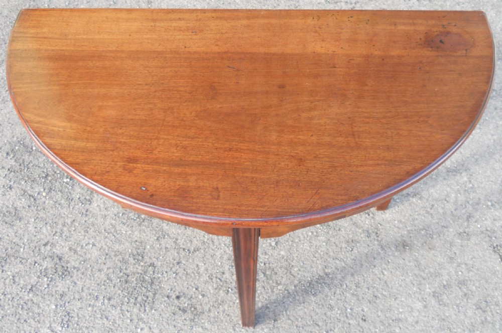 A Georgian mahogany drop-leaf side table featuring tapered legs and a curved apron. View VII