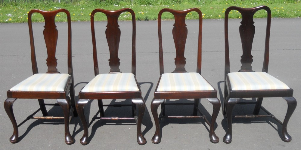 A set of four dark mahogany highback dining chairs featuring vase-shaped splats, cabriole legs, and striped upholstered drop-in seats. View II