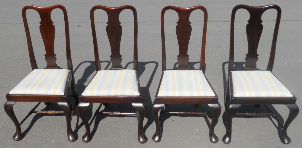 A set of four dark mahogany highback dining chairs featuring vase-shaped splats, cabriole legs, and striped upholstered drop-in seats. View III