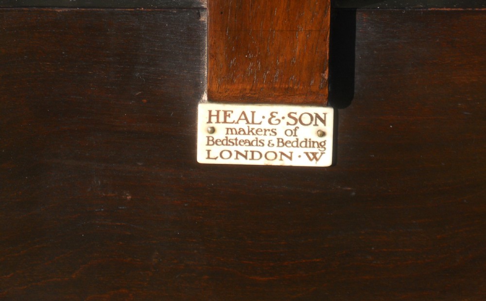 A pair of carved dark oak single bed frames displaying scroll-work horizontal rails, turned posts with finials, and solid lower panels. View III
