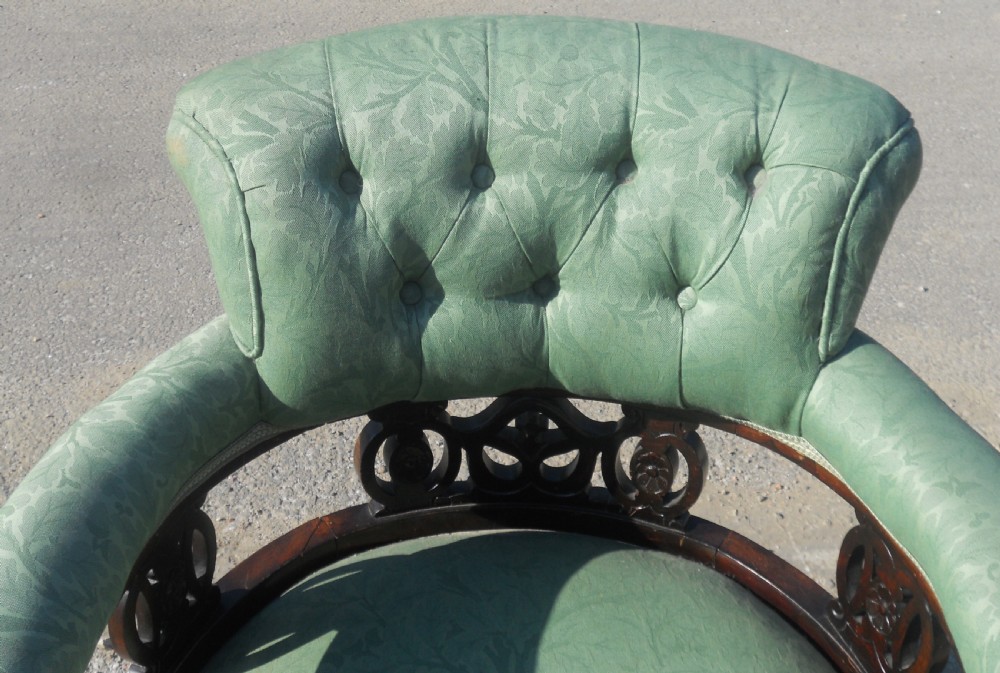 A pair of antique Art Nouveau mahogany armchairs upholstered in green patterned damask fabric with carved wooden frames and cabriole legs. View VII