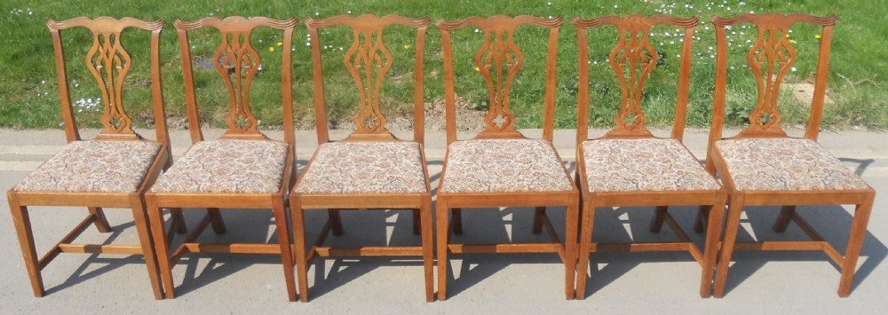 A set of eight warm brown oak Chippendale style dining chairs, comprising six side chairs and two carvers with patterned fabric drop-in seats. View III
