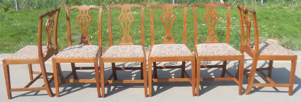 A set of eight warm brown oak Chippendale style dining chairs, comprising six side chairs and two carvers with patterned fabric drop-in seats. View IV