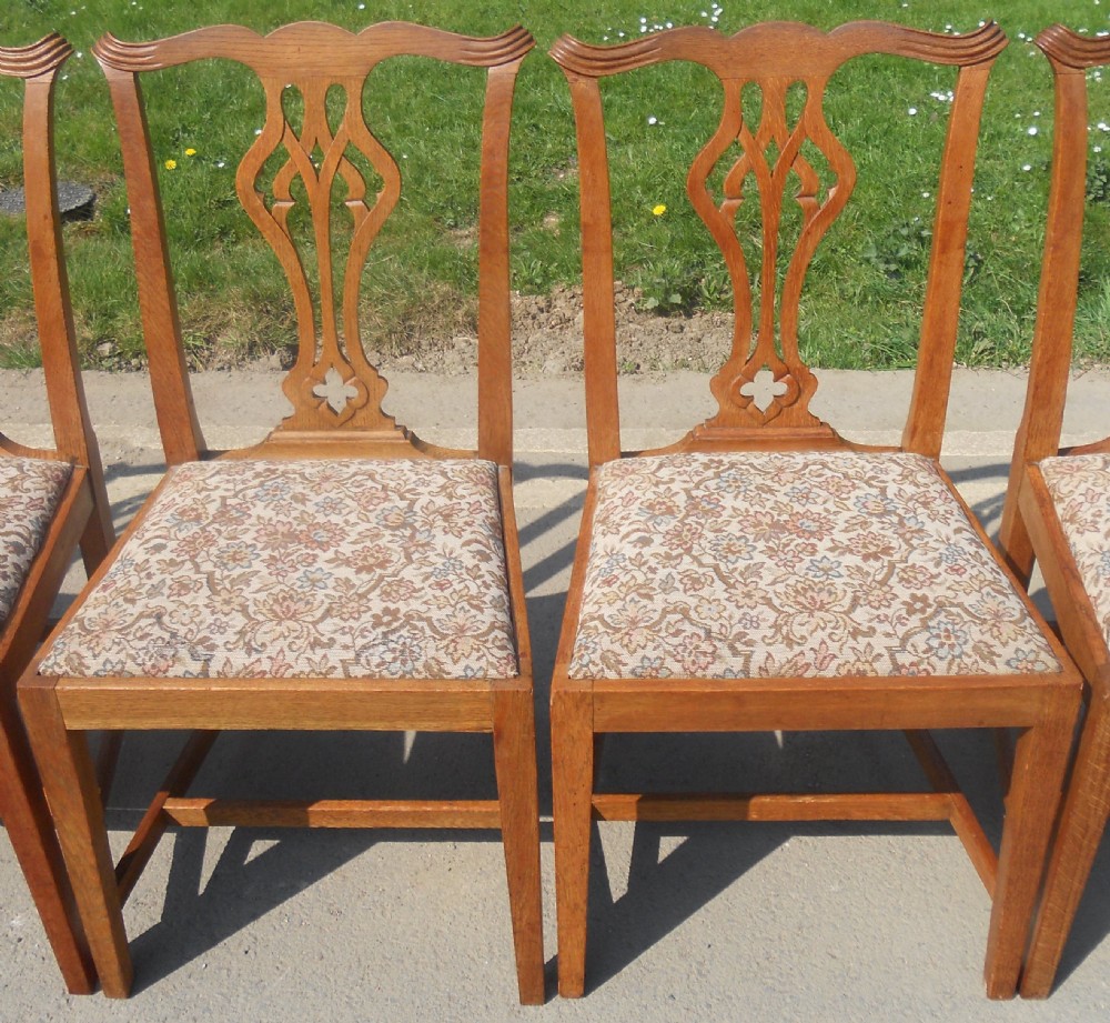 A set of eight warm brown oak Chippendale style dining chairs, comprising six side chairs and two carvers with patterned fabric drop-in seats. View V