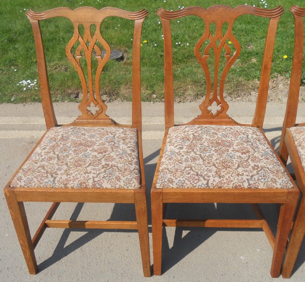 A set of eight warm brown oak Chippendale style dining chairs, comprising six side chairs and two carvers with patterned fabric drop-in seats. View VII