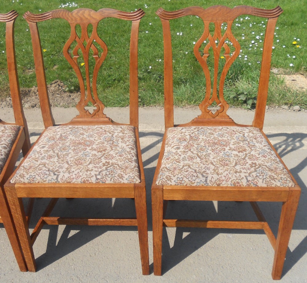 A set of eight warm brown oak Chippendale style dining chairs, comprising six side chairs and two carvers with patterned fabric drop-in seats. View VIII