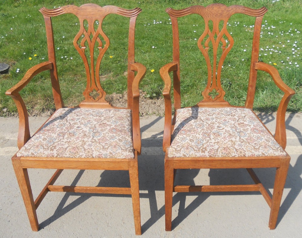 A set of eight warm brown oak Chippendale style dining chairs, comprising six side chairs and two carvers with patterned fabric drop-in seats. View IX