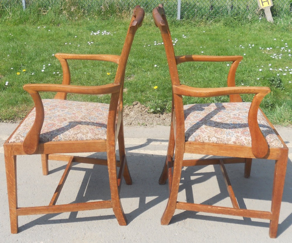 A set of eight warm brown oak Chippendale style dining chairs, comprising six side chairs and two carvers with patterned fabric drop-in seats. View X