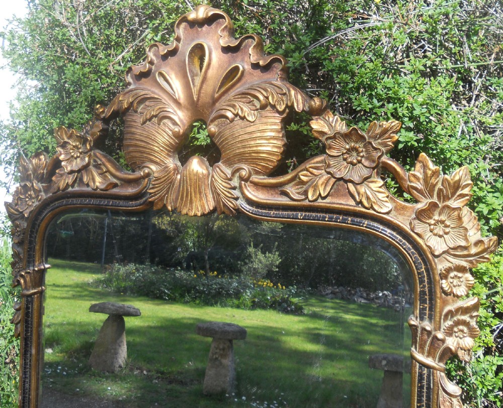 A large rectangular gold gilt wall mirror featuring an ornate shell and leaf carved crest. View II