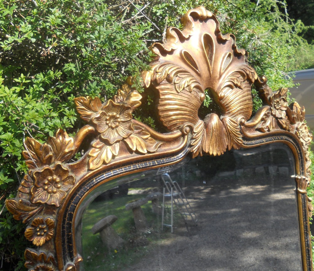 A large rectangular gold gilt wall mirror featuring an ornate shell and leaf carved crest. View III