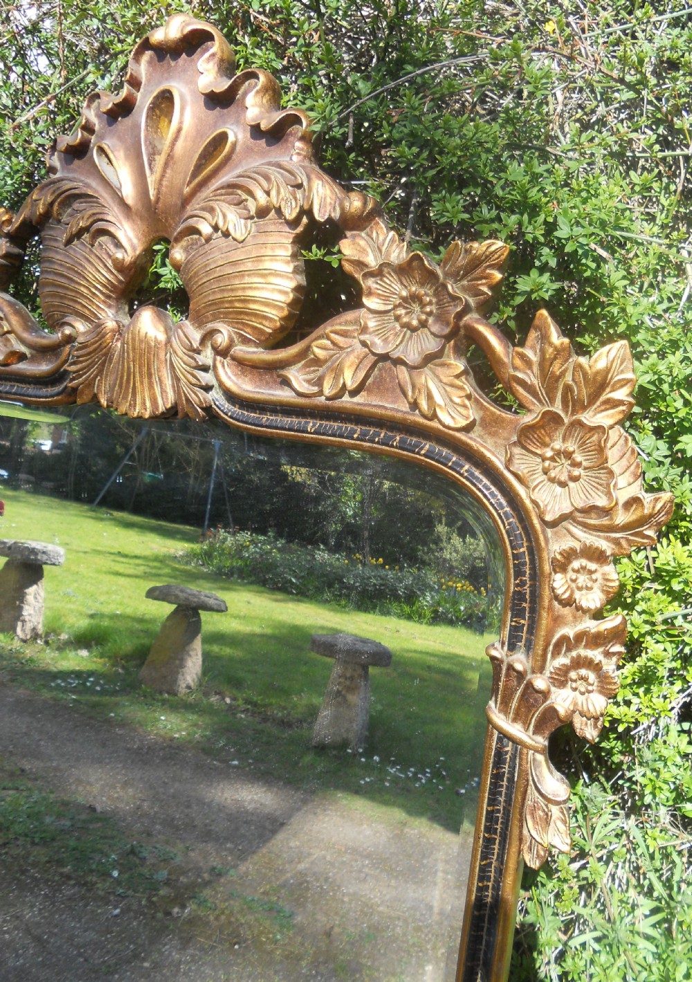 A large rectangular gold gilt wall mirror featuring an ornate shell and leaf carved crest. View VI